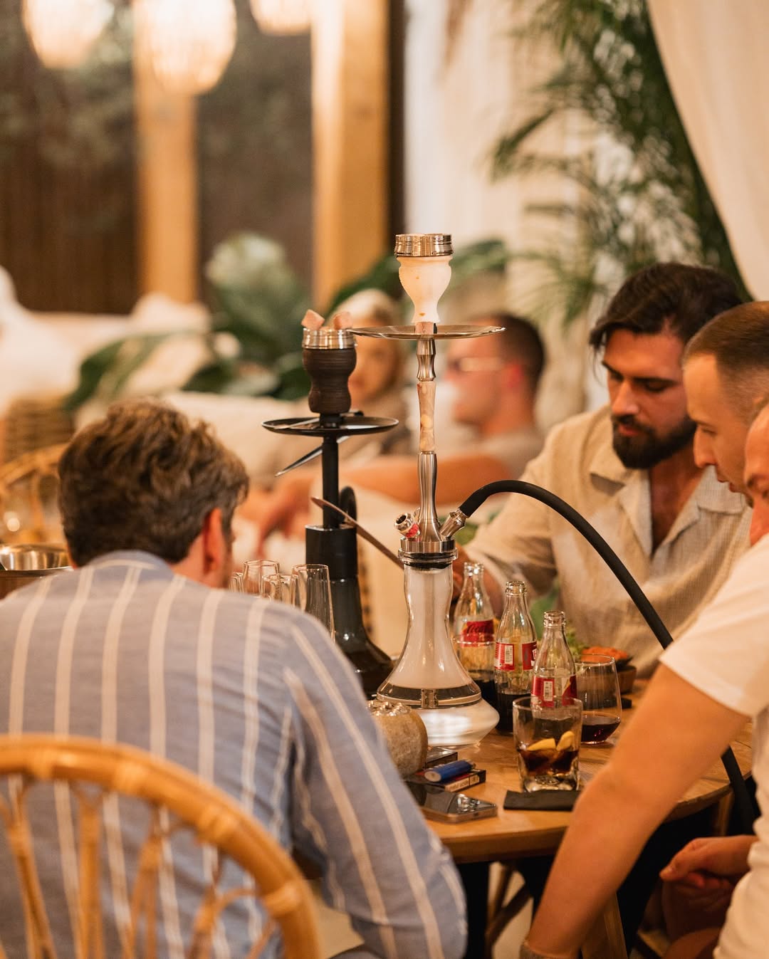 Group of friends at a table with shisha