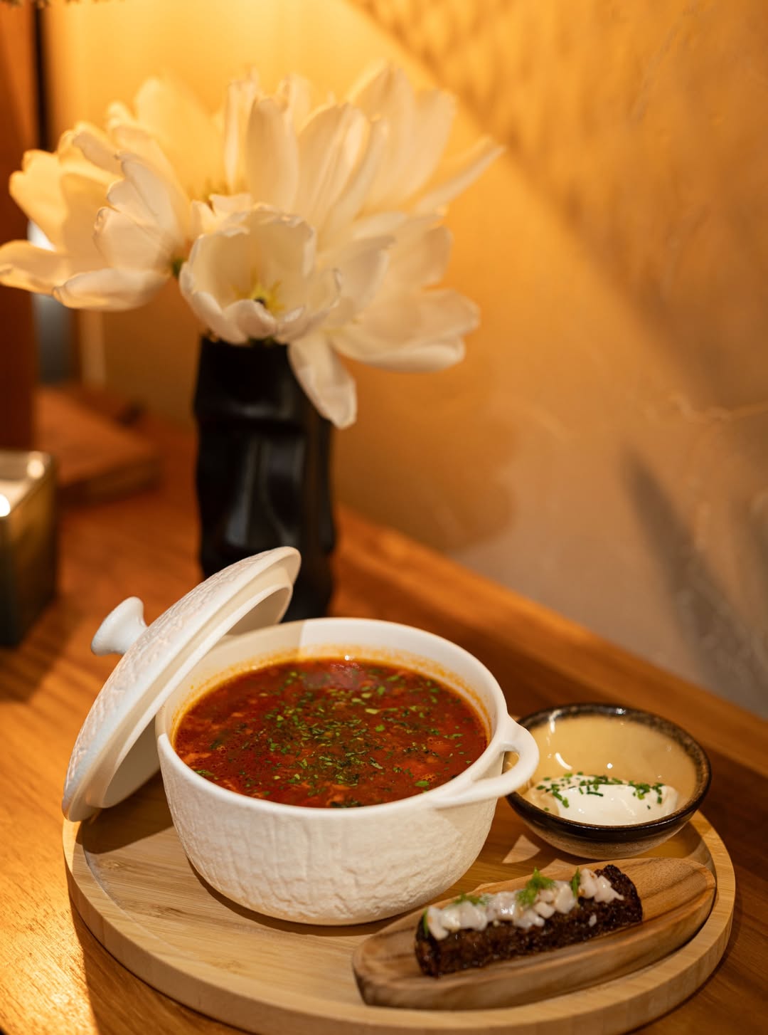 Bowl of borscht with sour cream and rye bread